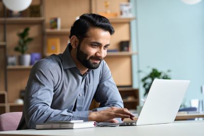 Professional with laptop in home office